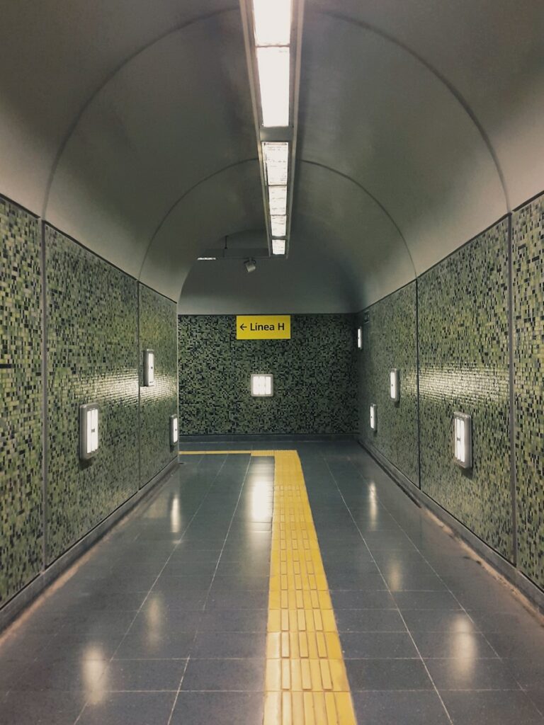 gray and yellow tunnel with yellow and white floor tiles