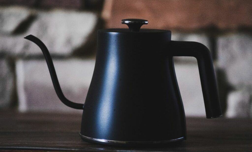 black kettle on brown wooden table